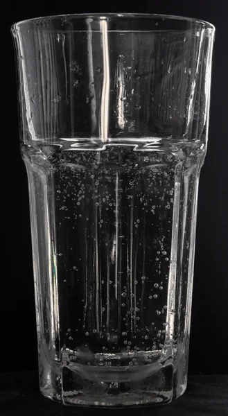 Glass with water on black — Stock Photo, Image