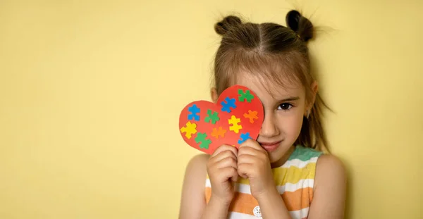 Una Hermosa Chica Sostiene Corazón Con Coloridos Puzzles Sus Manos —  Fotos de Stock