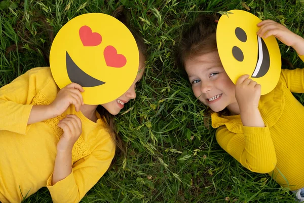 Little Girls Lying Lawn Covering Part Faces Emoticons Laughing Merrily — Stok Foto