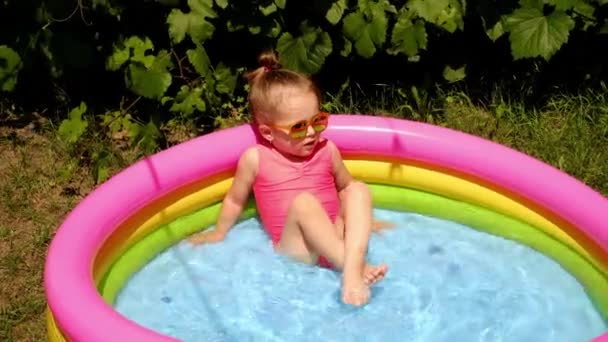 Una Bambina Schizza Acqua Una Piccola Piscina Gonfiabile Giardino Una — Video Stock