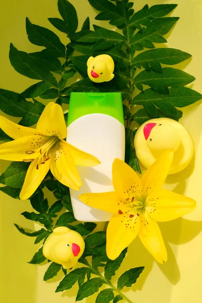 Means Bathing White Bottle Background Tropical Plants Yellow Lilies Toy — Stock Photo, Image