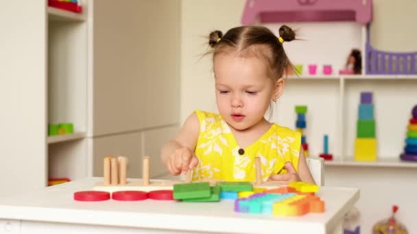 Ett Tvåårigt Barn Leker Vid Ett Bord Barnrummet Med Leksaker — Stockvideo
