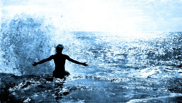 Ocean Wave Splashing on a Man sitting on a cliff — Stock Photo, Image