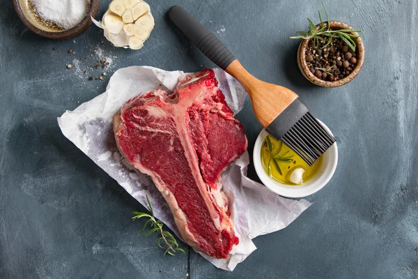 Thick raw T-bone steak with seasoning — Stock Photo, Image