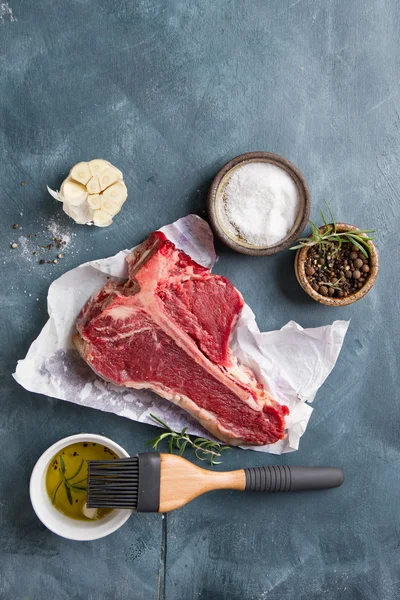 Thick raw T-bone steak with seasoning — Stock Photo, Image