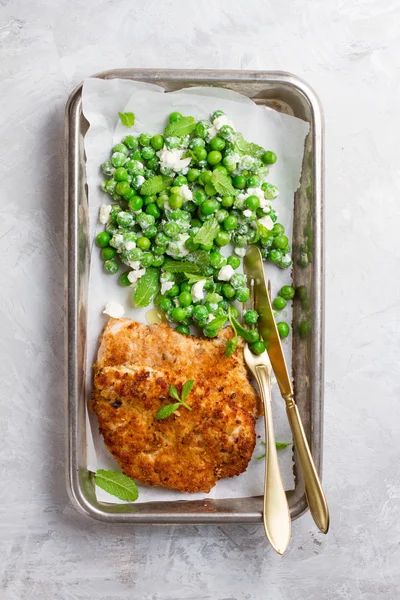 Chicken or pork schnitzel with cheese and  peas salad — Stock Photo, Image