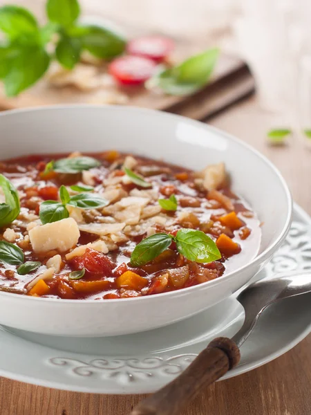 Minestrone soup with cheese and basil — Stock Photo, Image