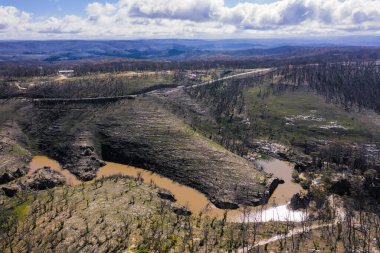 Yeni Güney Galler Avustralya 'daki Orta Tablolar' daki Dargan 'daki orman yangınları sonrasında orman yenilenmesi ile çevrili bir su deposunun havadan görünüşü