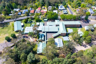 Springwood Devlet Okulu 'nun insansız hava aracı fotoğrafı Avustralya' nın NSW kentindeki Springwood kasabasında bulunan yemyeşil yapraklar arasında yer almaktadır..