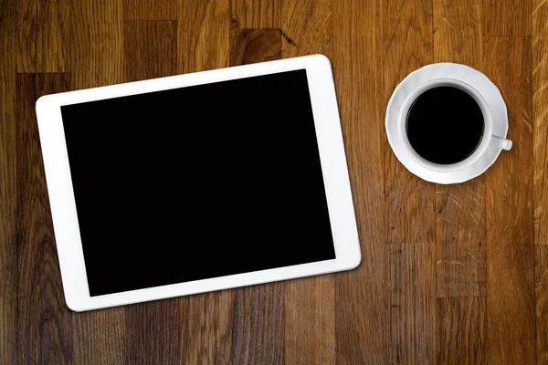 Tablet e café na mesa de madeira velha — Fotografia de Stock