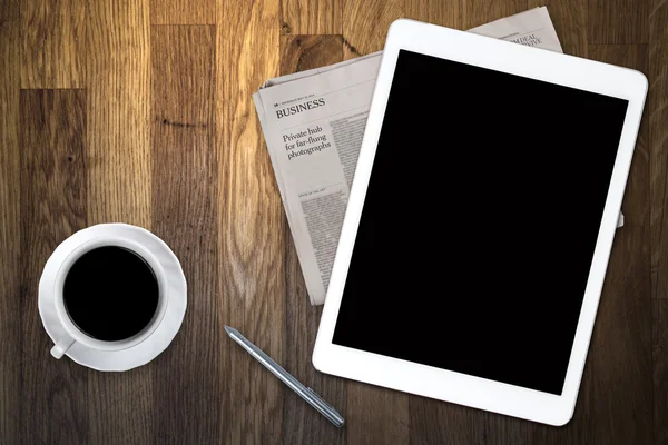 Tablet and coffee on old wooden table — Stock Photo, Image