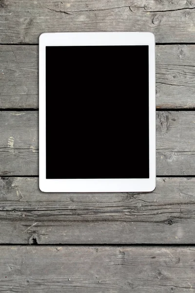 Tablet computer on old wooden table — Stock Photo, Image