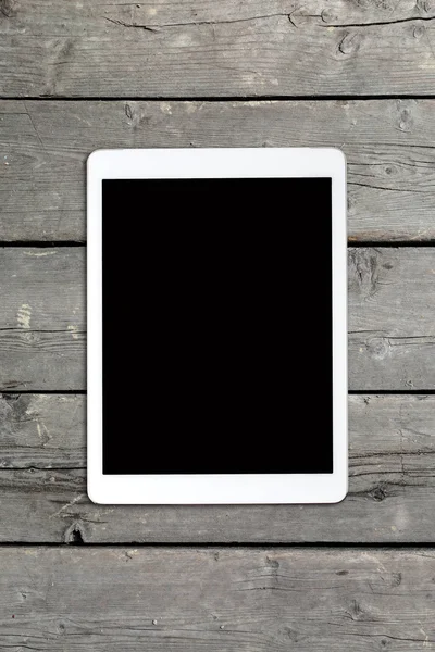 Tablet computer on old wooden table — Stock Photo, Image