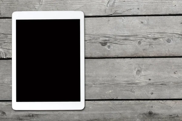 Tablet computer on old wooden table — Stock Photo, Image