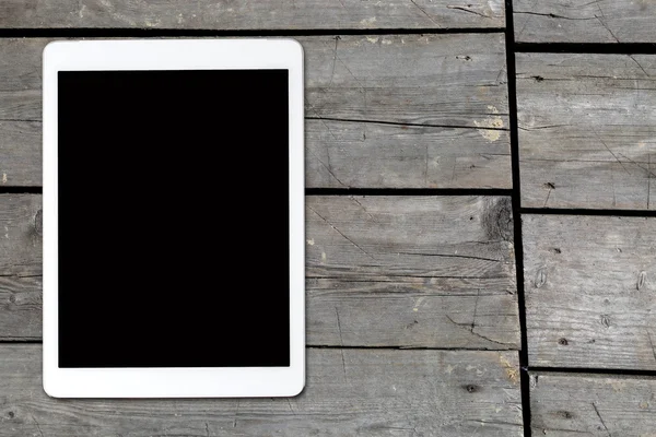 Tablet computer on old wooden table — Stock Photo, Image