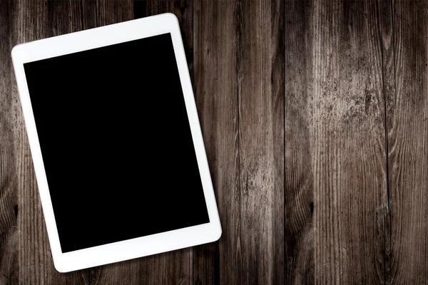 Tablet computer on old wooden table — Stock Photo, Image