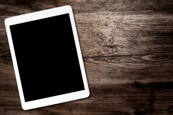 Tablet computer on old wooden table — Stock Photo, Image