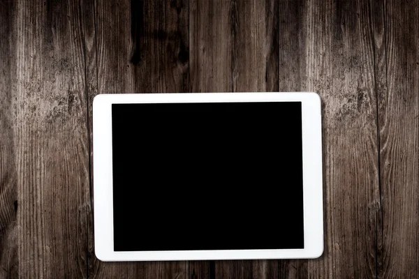 Tablet computer on old wooden table — Stock Photo, Image