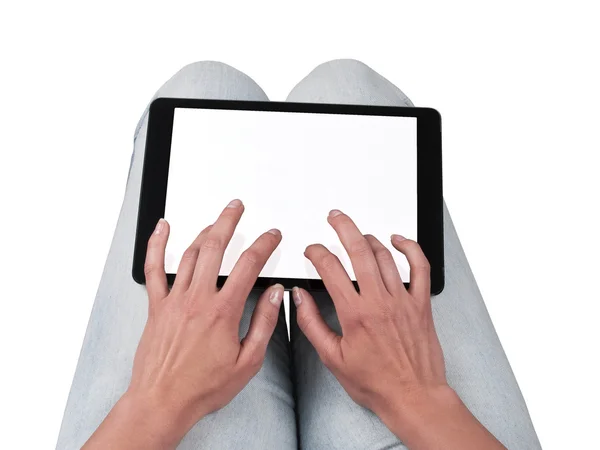 Woman writes on the tablet lying on the thighs Royalty Free Stock Photos