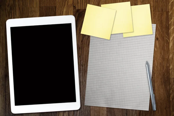 Digital tablet computer with sticky note paper and cup of coffee on old wooden desk. Simple workspace or coffee break with use of web . — Stock Photo, Image