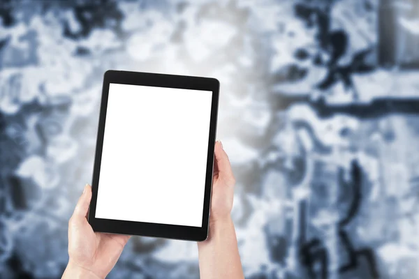 Tablet in the hands of women and graffiti in the background — Stock Photo, Image