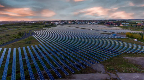 Solar battery farm a new way to generate green energy, drone photo at sunset, Colombelles, Normandy, France