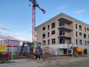 Caen, France December 17, 2025. Construction of new apartments, construction site with crane and machinery