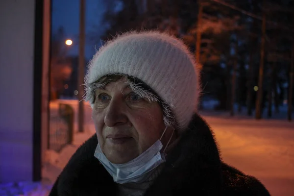 Sokakta şapkalı yetişkin bir kadın.