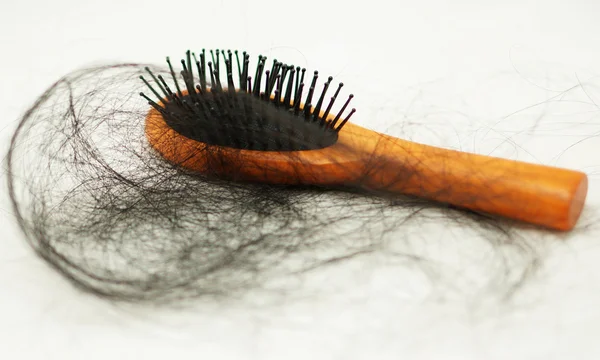 Many hair attached to a comb after use — Stock Photo, Image