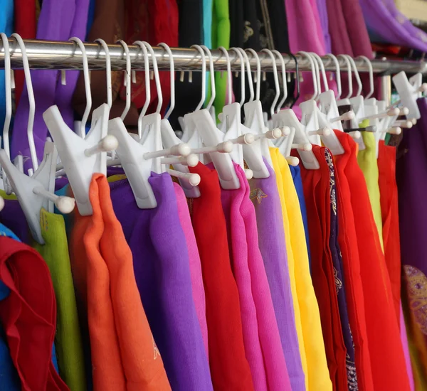Row of colourful clothes hanging on iron railing Stock Picture
