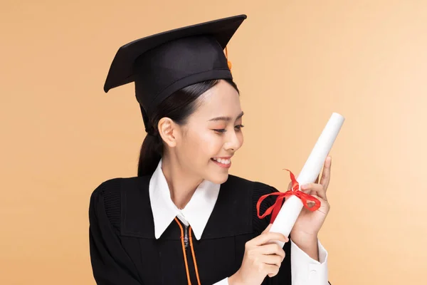 Happy Graduate Asian Woman Cap Gowm Holding Certificated Diploma Beige — Stok Foto