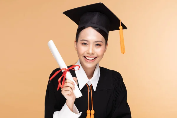 Happy Graduate Asian Woman Cap Gowm Holding Certificated Diploma Beige — Stok Foto