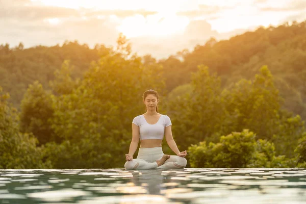 Beautiful Attractive Asian Woman Practice Yoga Lotus Pose Pool