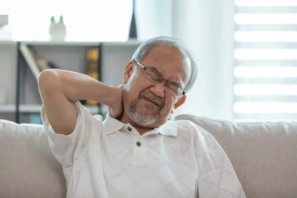 Asian Elderly senior man neck and shoulder pain and illness