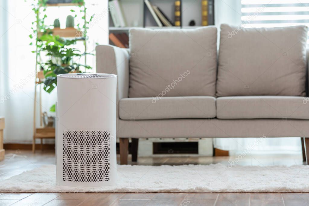 Air purifier in cozy white Living room for filter and cleaning removing dust PM2.5 HEPA in home,for fresh air and healthy life,Air Pollution Concept
