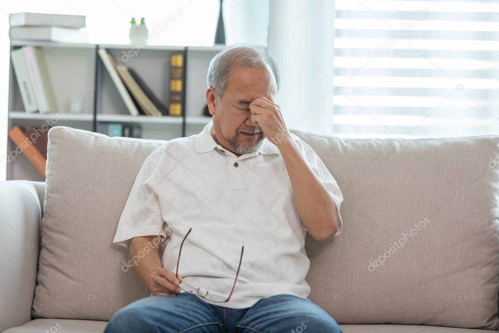 Asian Elderly senior man headache and migraine so pain and illness