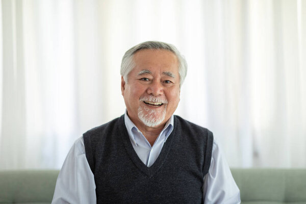 Healthy Asian Elderly man with white hairs smile so happiness and cheerful at home,Portrait of senior man enjoying retirement at home concept
