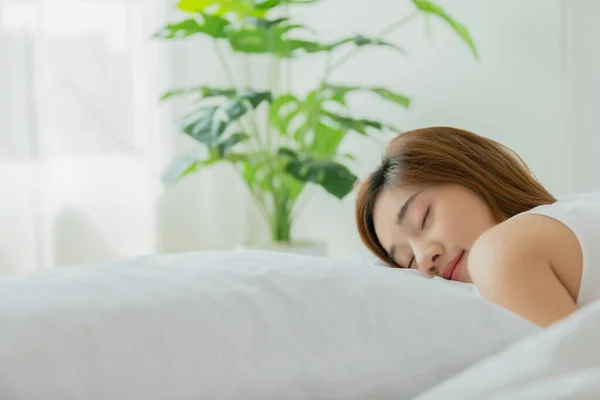 Beautiful Attractive Asian woman sleep and sweet dream lying on bed in cozy bedroom in the morning feeling so relax and comfortable,Healthcare Concept