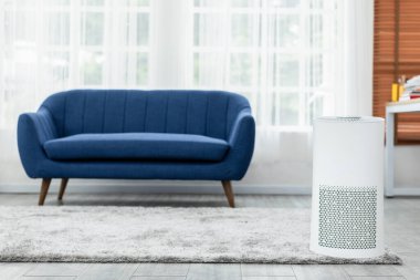 Evdeki toz PM2.5 HEPA ve virüsü filtrelemek ve temizlemek için rahat beyaz yatak odasındaki hava temizleyicisi, temiz hava ve sağlıklı yaşam için, hava kirliliği kavramı