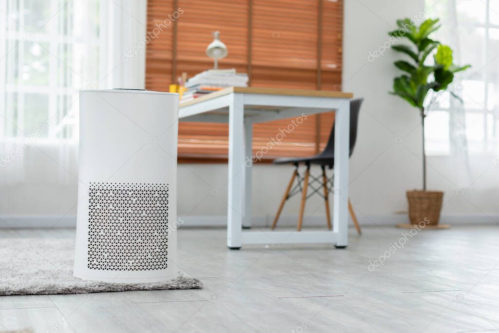 Air purifier in cozy white bedroom for filter and cleaning removing dust PM2.5 HEPA and virus in home,for fresh air and healthy Wellness life,Air Pollution Concept