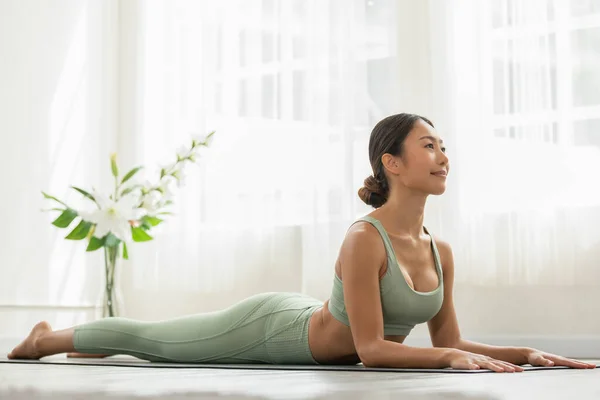 Calm Attractive Asian Woman Practice Yoga Cobra Pose Meditation Home — Stock Photo, Image