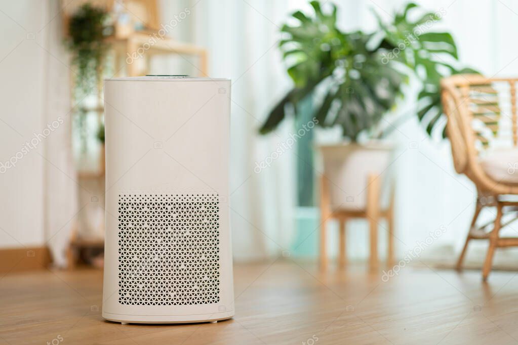 Air purifier in cozy white living room for filter and cleaning removing dust PM2.5 HEPA and virus in home,for fresh air and healthy Wellness life,Air Pollution Concept