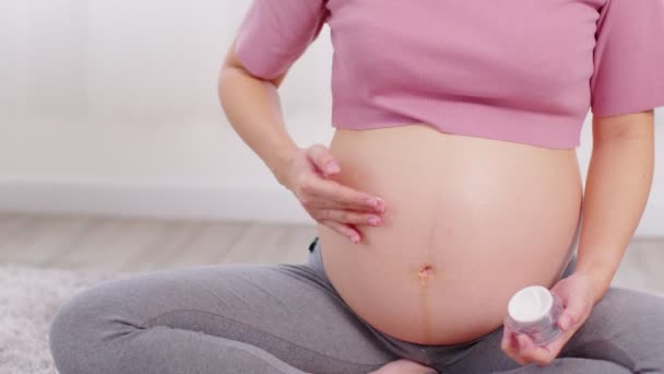 Nahaufnahme Schwangere Bett Sitzend Und Streichelnd Creme Auf Dicken Bauch — Stockvideo