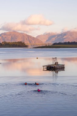 loch leven 7 am three people going for a swim clipart