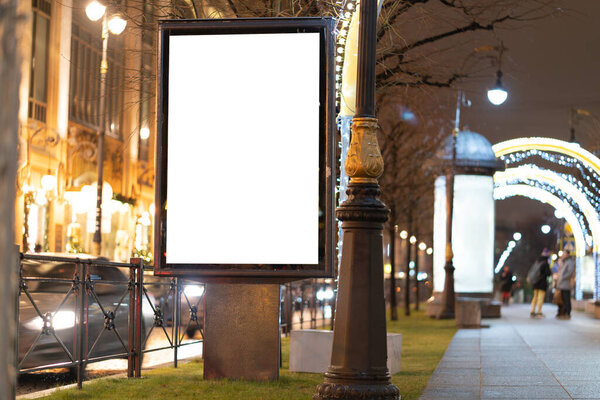 glow box vertical billboard evening glowing on the street.