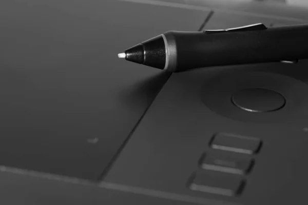graphic tablet with a pen lying on it background.
