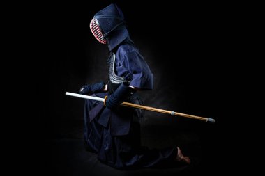 Bokuto 'lu dövüşçü. Siyah bir arkaplanda diz çökmek. Kendo Üniformalı Dövüşçü