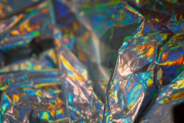 Yanardöner kumaş holografik arka plan. Buruşmuş folyo yüzeyi