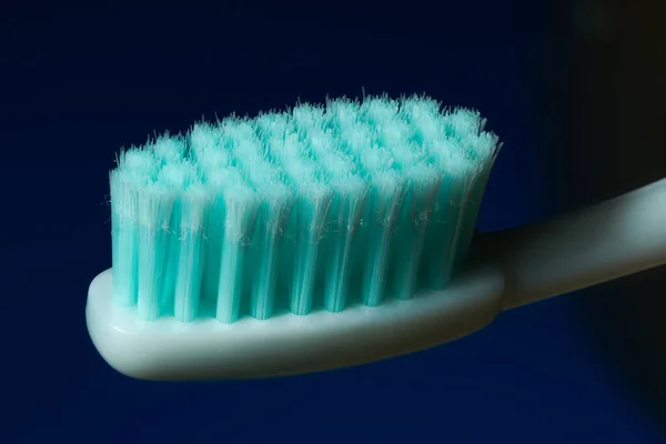 White Toothbrush Aquamarine Bristles Black Blue Background — Stock Photo, Image