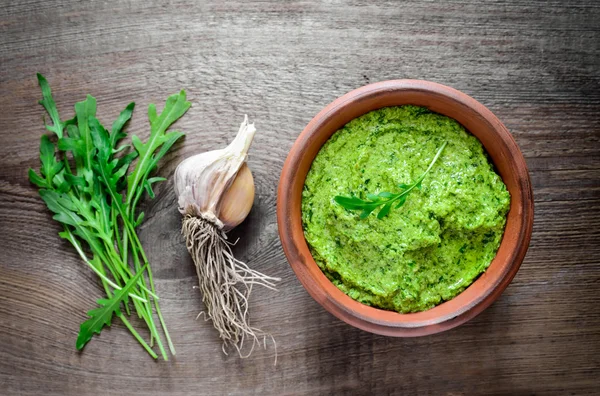 Arugula pesto in a rustic bowl — Stock Photo, Image